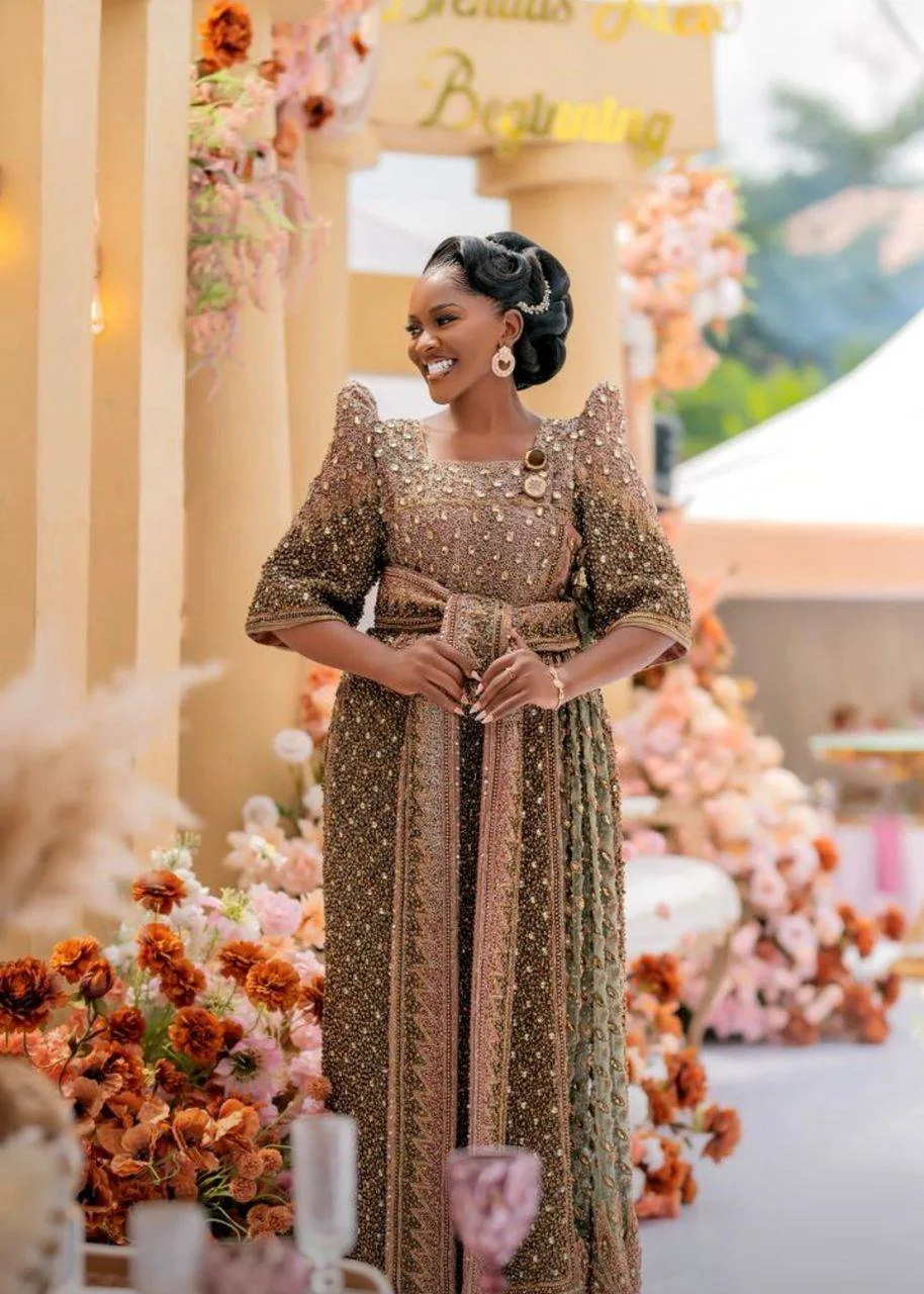 Traditional Ugandan bridal Gomesi styling with gold accessories